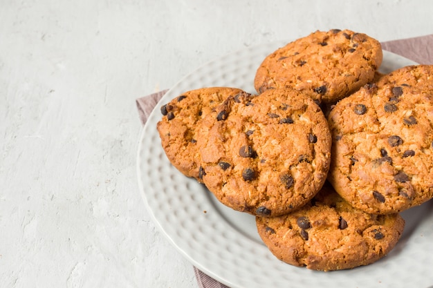 Homemade cookies with chocolate in a plate on a grey table. Chocolate chip cookie shot