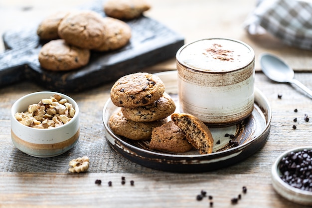 Homemade cookies with nuts and coffee in a ceramic cup