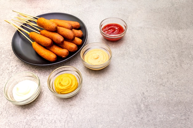 Homemade corn dogs with sauces