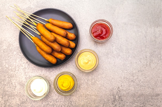 Homemade corn dogs with sauces