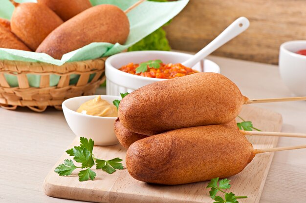 Homemade corn dogs with sauces