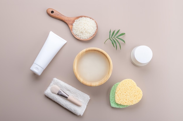 Homemade cosmetic rice water with ingredients on beige background healthy beauty treatment ingredients for homemade comsetics beauty recipe for home spa natural skincare preparation top view