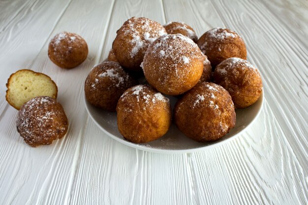 Homemade cottage cheese donuts on the white  wooden background