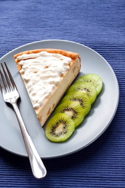 Homemade cottage cheese and semolina cake with kiwi fruit and cream