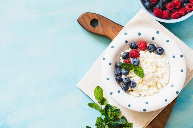 Homemade Cottage cheese with berries and mint Cottage cheese in a bowl Dairy products