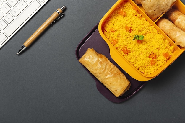 Homemade Couscous in a lunch box with vegetables and typical Arabic food Take away Food in work concept