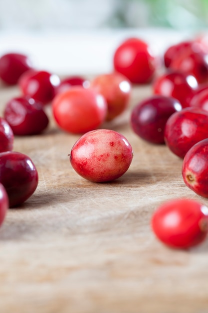 Homemade cranberries grown in an industrial garden, red sour healthy cranberries, red ripe cranberries on the table