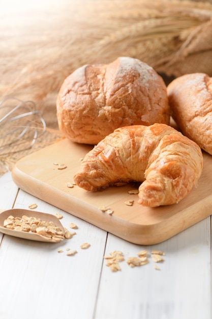 Homemade croissant and bread on old wood 