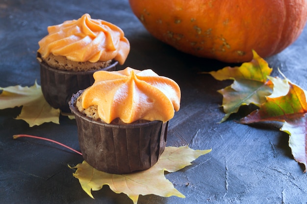 Homemade cupcakes with cream. on dark .