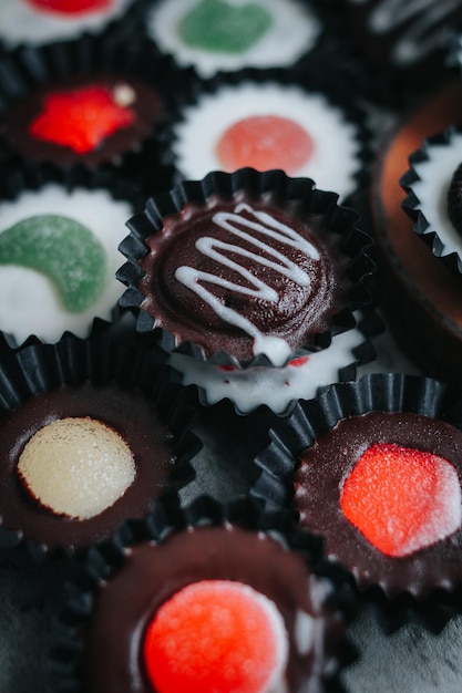 Homemade dark chocolate and white cup on a black pack chocolate cup with rustic grey background