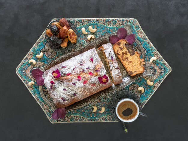 Homemade date and walnut cake on black table