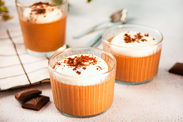 Homemade delicious chocolate mousse panna cotta pudding whipped cream in a glasses