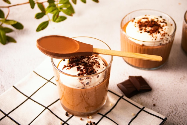 Homemade delicious chocolate mousse panna cotta pudding whipped cream in a glasses