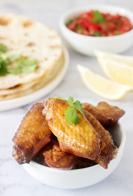 Homemade delicious food of tortillas, salsa and fried wings.