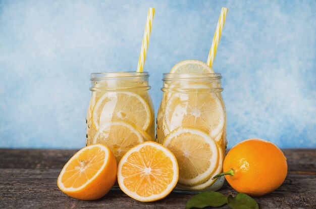 Homemade detox water with lemon in a glass jar  