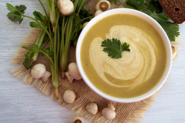 Homemade diet mushroom soup on a light background.