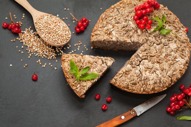 Homemade dietary buckwheat bread close up perspective view on a black background