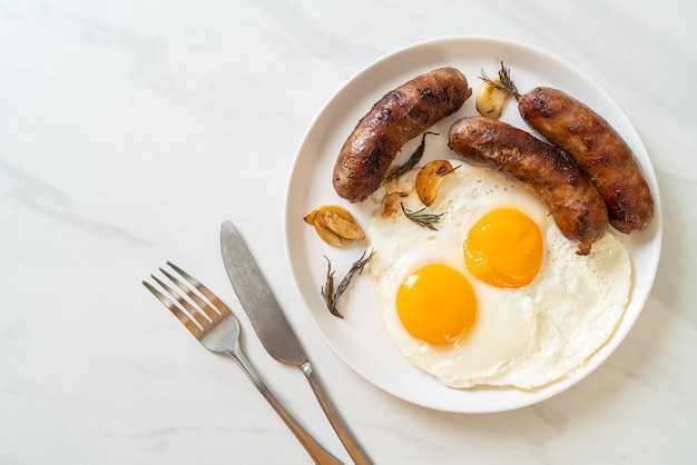 homemade double fried egg with fried pork sausage - for breakfast