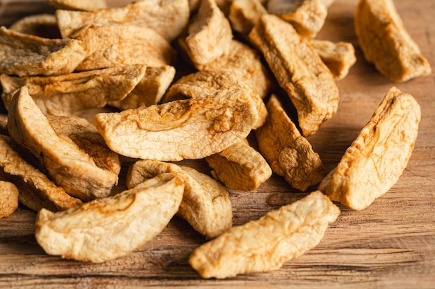 Homemade dried organic apple sliced on wood background