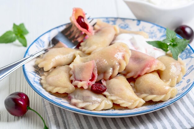 Homemade dumplings pierogi with cherries