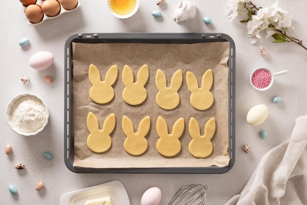 Homemade Easter bunnies shaped cookies in oven tray Top view