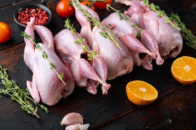 Homemade eco friendly raw quails, on dark wooden table