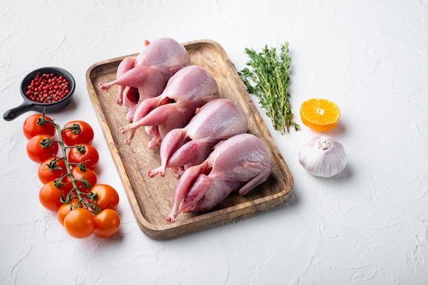 Homemade eco friendly raw quails, on white textured background  with copy space