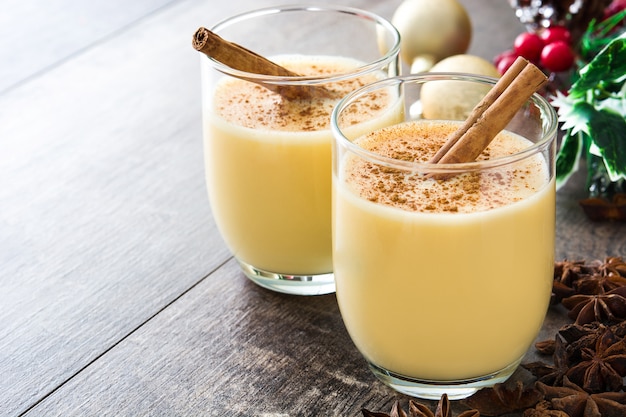 Homemade eggnog with cinnamon on wood table, Typical Christmas dessert