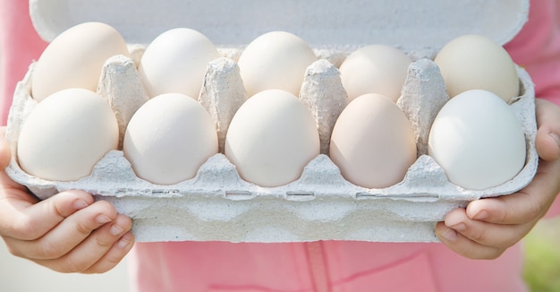 Homemade eggs in the hands of a child. 