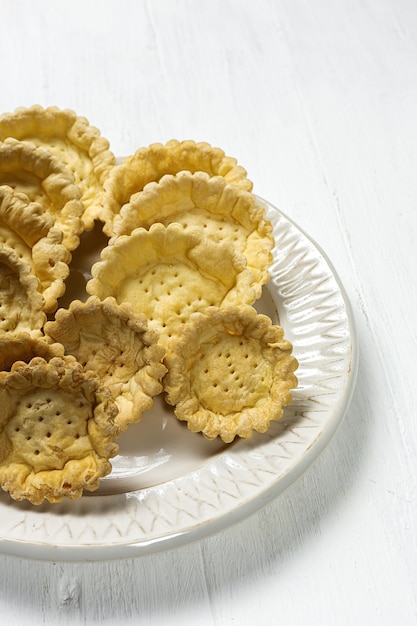 Homemade empty tartlets on white background isolated