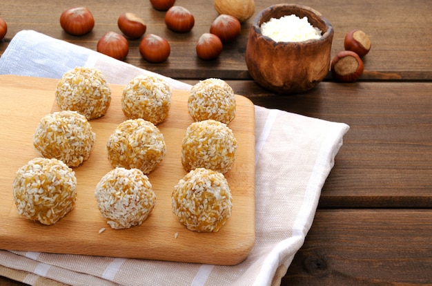 A homemade energy balls with shredded coconut on a cutting board