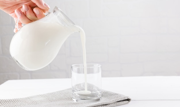 Kefir di bevande fermentate fatte in casa con chicchi di kefir in una ciotola su uno sfondo bianco, concetto di cibo fermentato naturale e salute intestinale