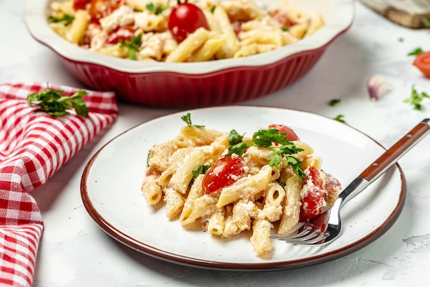 Homemade feta pasta, oven baked cherry tomatoes and feta cheese with olive oil