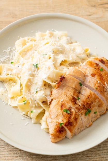 homemade fettucine pasta white creamy sauce with grilled chicken