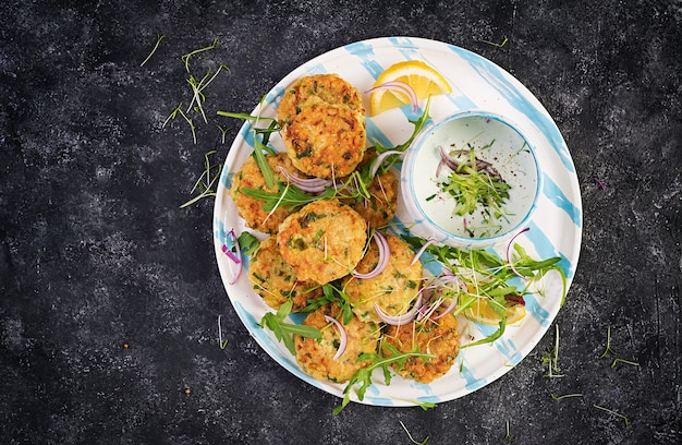 Crocchette di pesce fatte in casa con pesce bianco, bulgur, spinaci e pangrattato. frittelle di baccalà tritato. pranzo o cena deliziosi e nutrienti. vista dall'alto, dall'alto