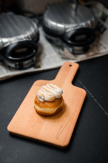 Homemade flavored doughnuts on wooden board