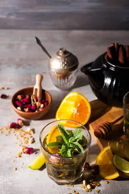 Homemade flavored orange iced tea on stone background