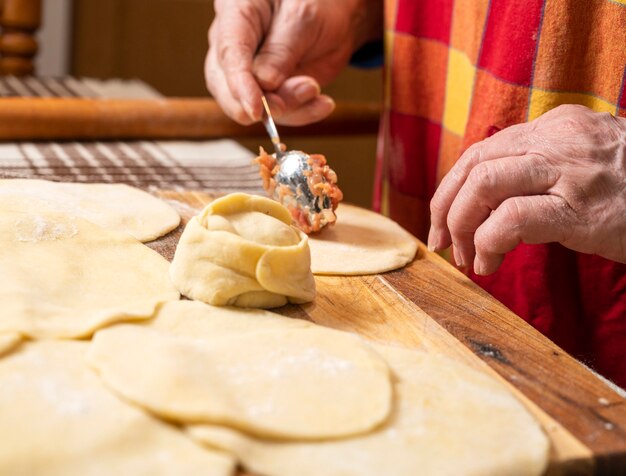 Homemade food concept. Woman making  manti  with minced beef meat