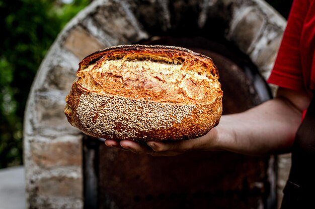 Homemade fresh bread in the baker39s hand