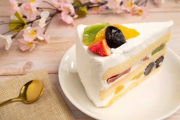 Homemade fresh fruits Sponge cake sweet desserts topped and stuffed with fresh kiwi and blueberries