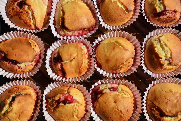 Homemade freshly baked black currant jam muffins on baking tray