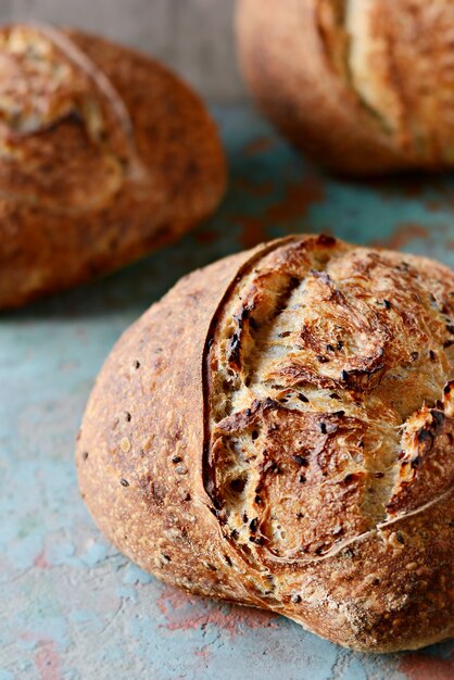 Homemade Freshly Baked Country Bread  made from wheat and whole grain flour on a dark surface. French Freshly baked bread.