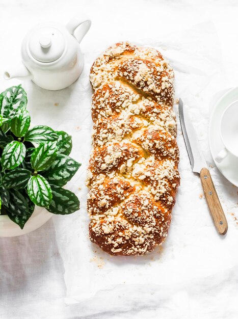 Homemade freshly baked hala on a light background top view