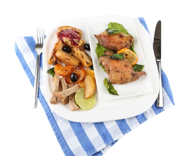 Homemade fried chicken drumsticks with vegetables on plate isolated on white