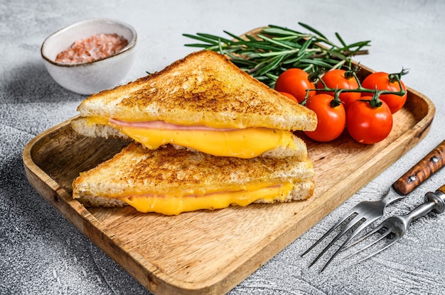 Homemade fried ham and cheese sandwich on a cutting board