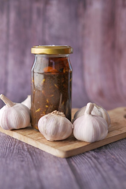 Homemade Garlic Pickle in a glass jar on table