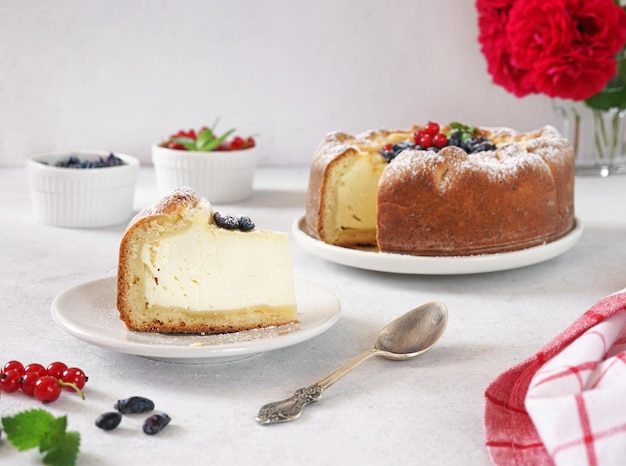 Homemade german cheesecake kasekuchen with berries on beautiful plate on table natural light