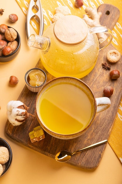 Homemade ginger tea with honey in glass teapot