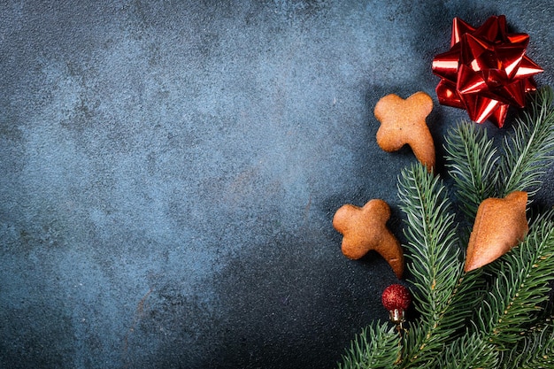 Homemade gingerbread cookies on dark background Christmas composition new year background Christmas dessert New Year flatlay