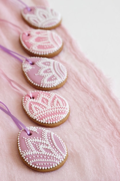 Homemade gingerbread Easter lilac and pink color in the form of egg with a floral design.